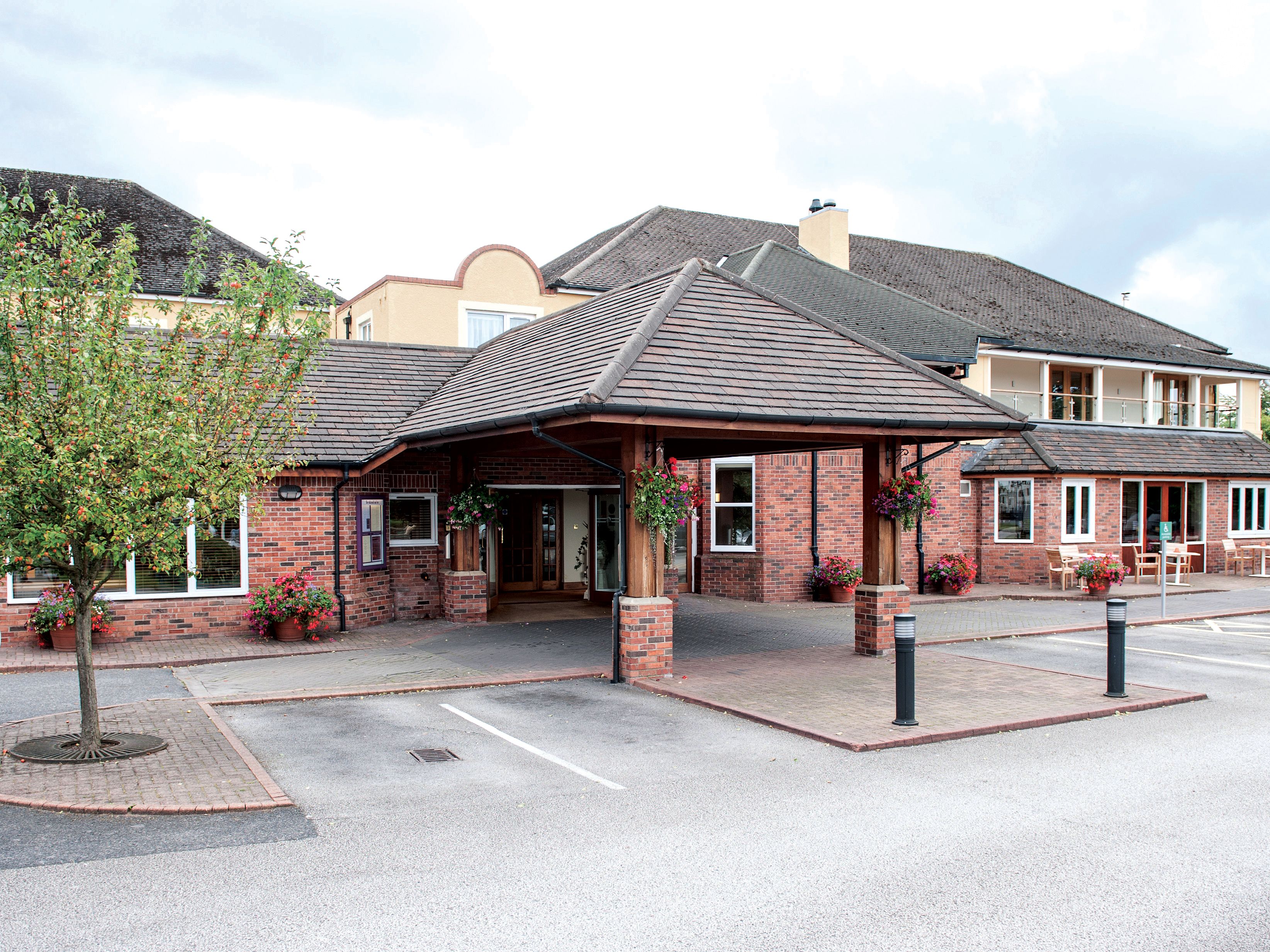 brick building with entrance canopy and parking lot