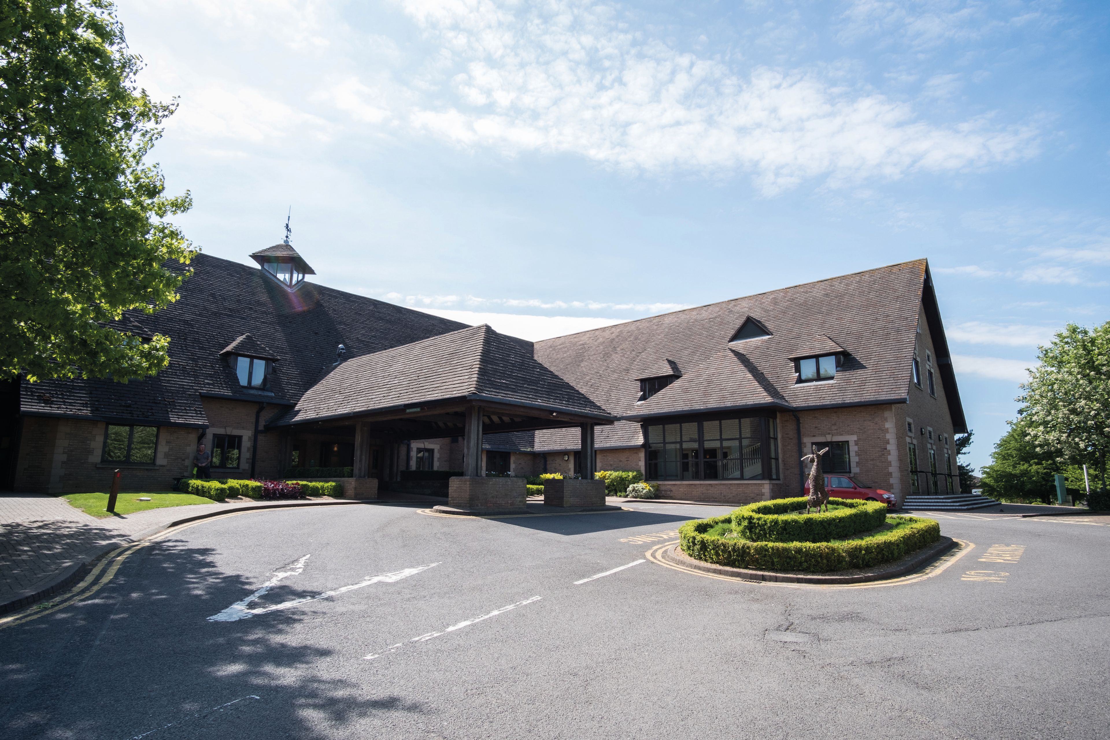 brick hotel building with a circular driveway