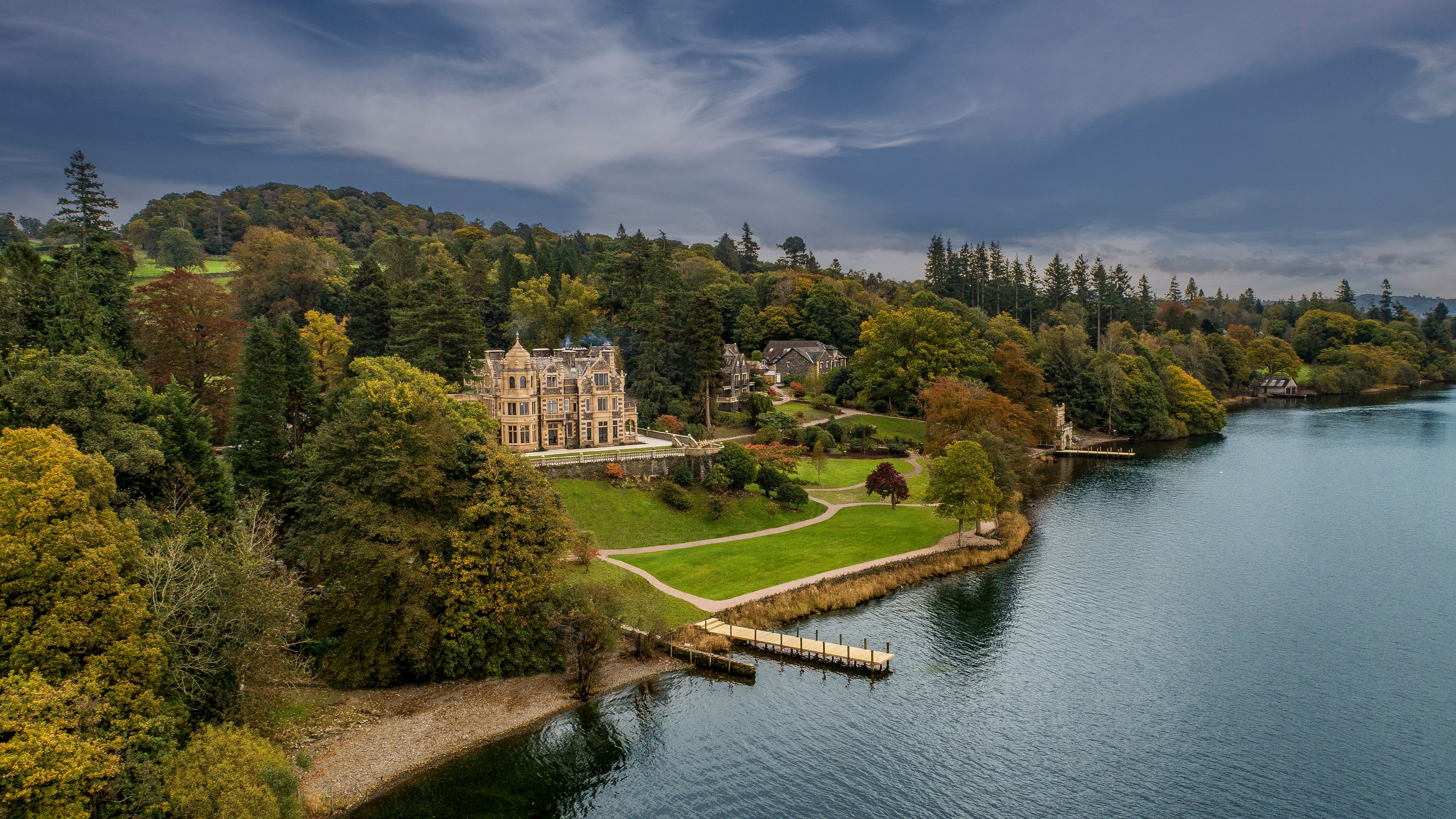 A view of the hotel which is situated close to a lake and surrounded by greenery