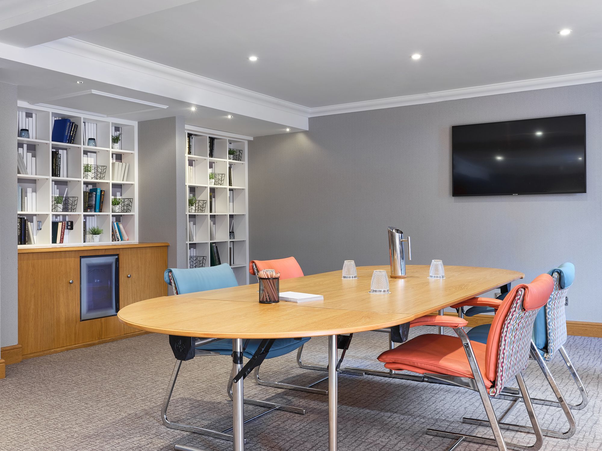 a light meeting room with a table and 4 chairs