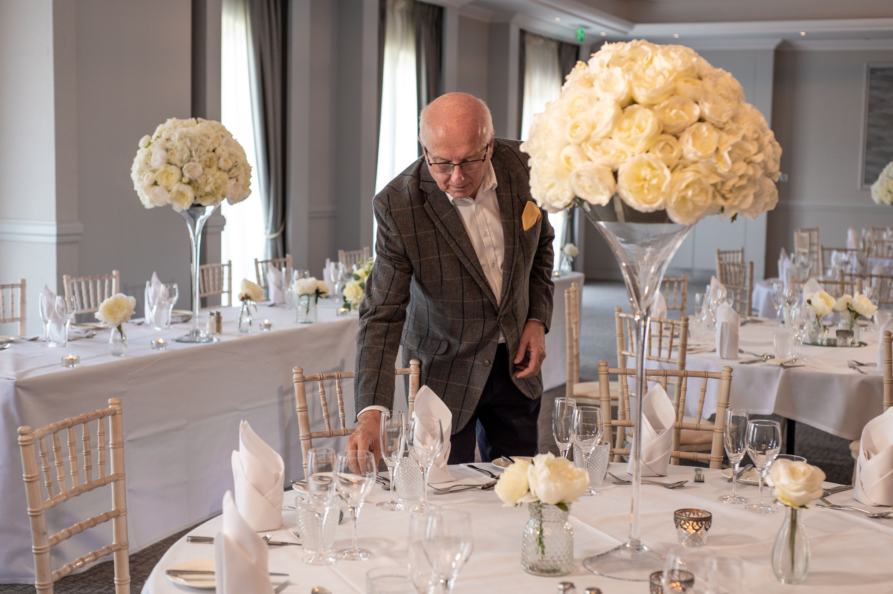 man setting table up for wedding