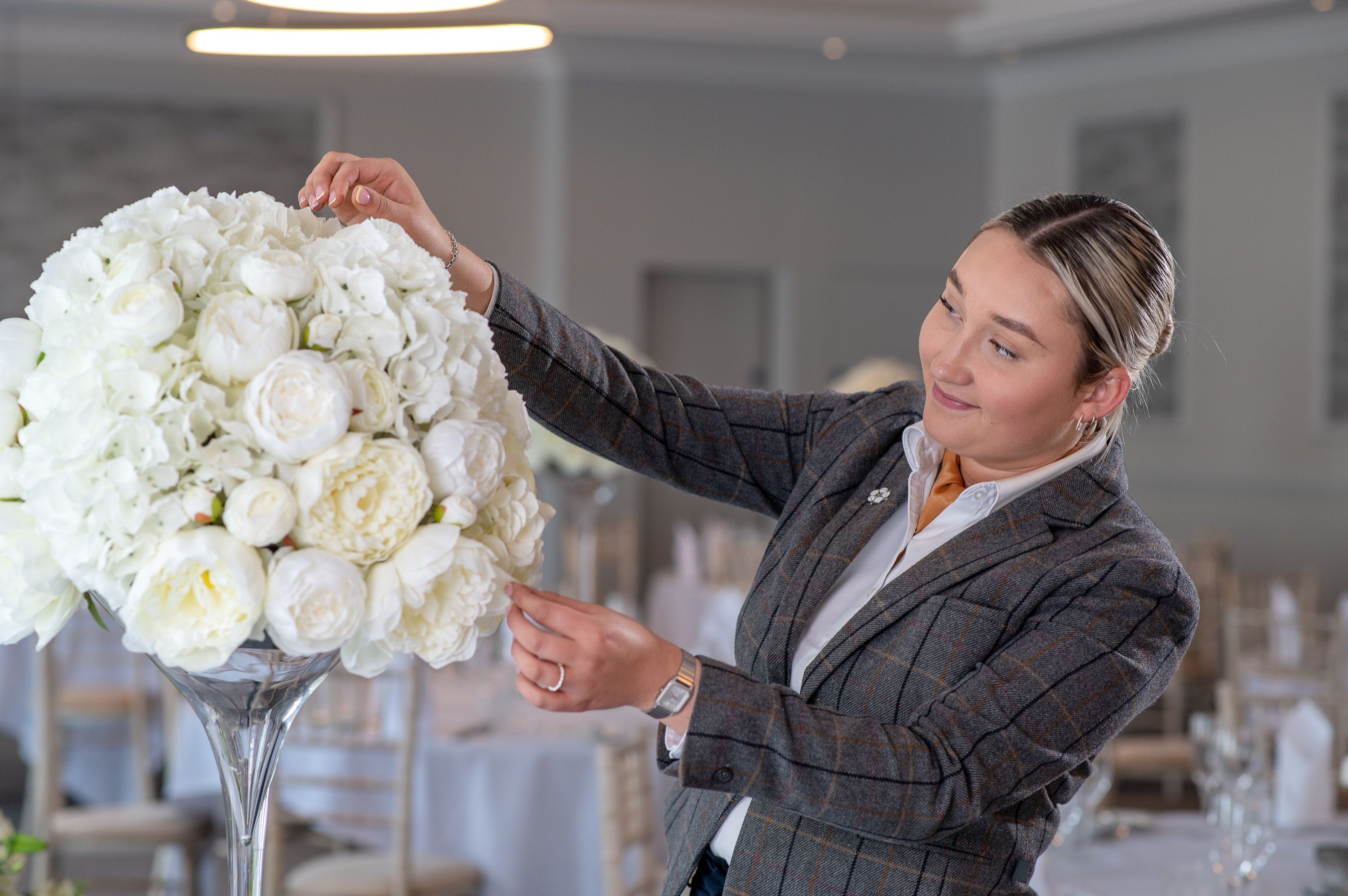 lady arranging flower centre piece